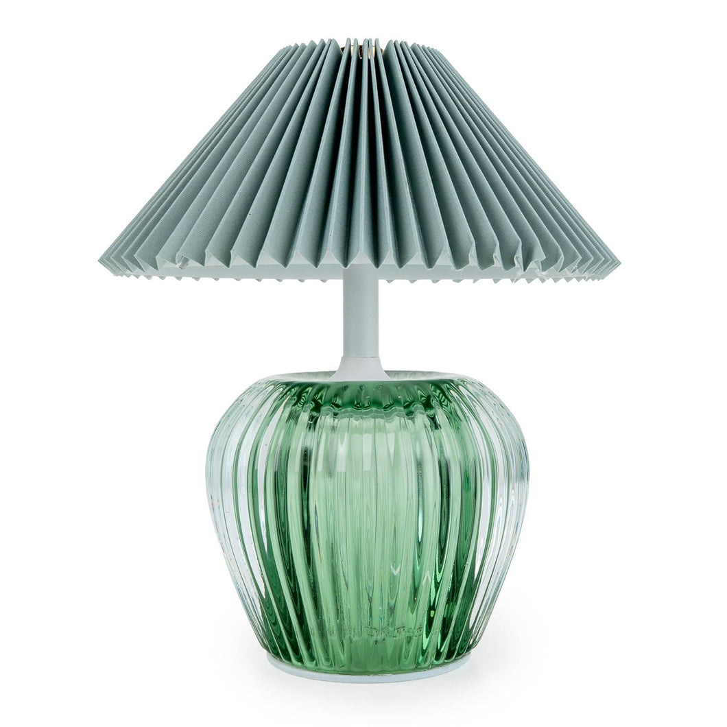 Portable LED table lamp with a chunky ribbed green glass base and a wide pleated grey fabric shade, photographed on a white background