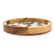 Round mango wood serving tray with cut-out handles, a low natural wood rim, and a white botanical orange and leaf print interior, photographed from a slight angle on a white background
