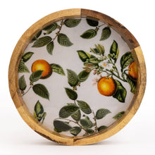 Round mango wood plate with a natural wood rim and a white interior featuring a detailed botanical illustration of ripe oranges, green leaves, and delicate blossoms, photographed on a white background